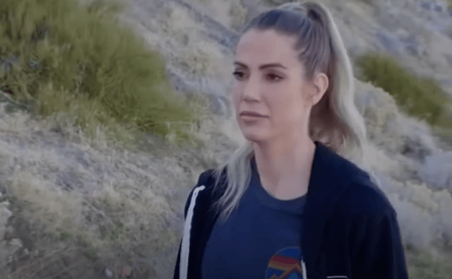 Young woman with hair in a pony tail walking outside