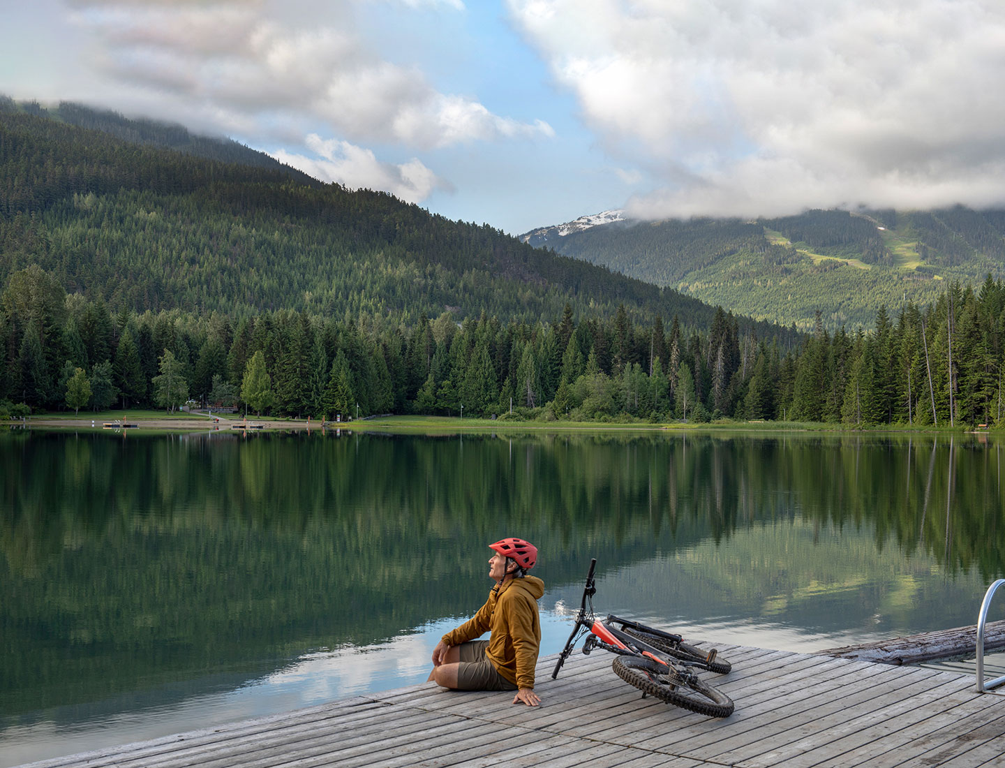 senior biking by lake
