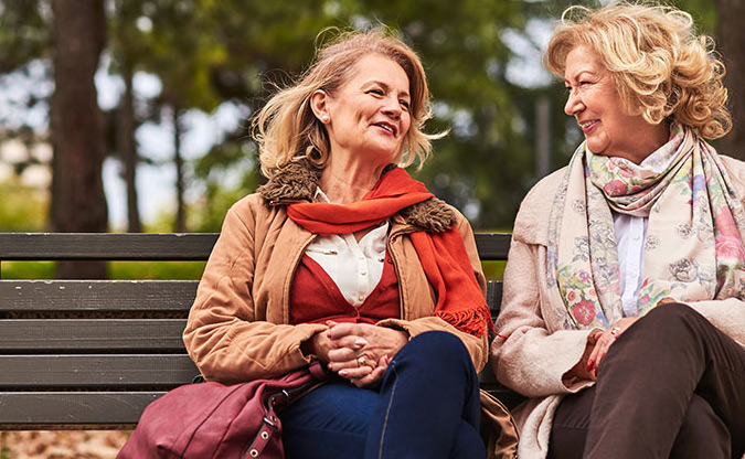 women sitting on a bench