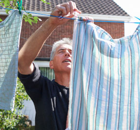 man hanging clothes